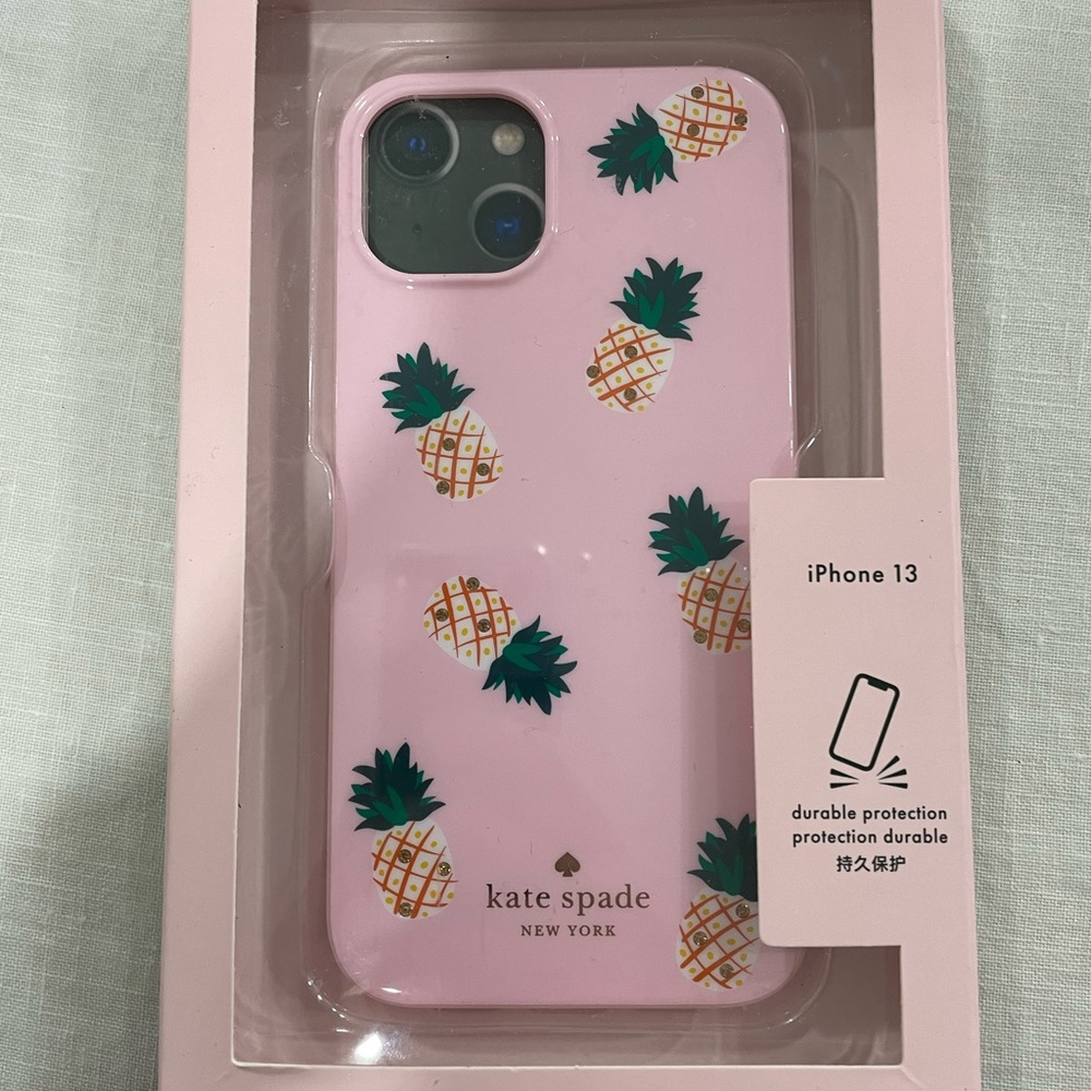 Kate Spade iPhone 13 case. Pineapple design with light pink background.
